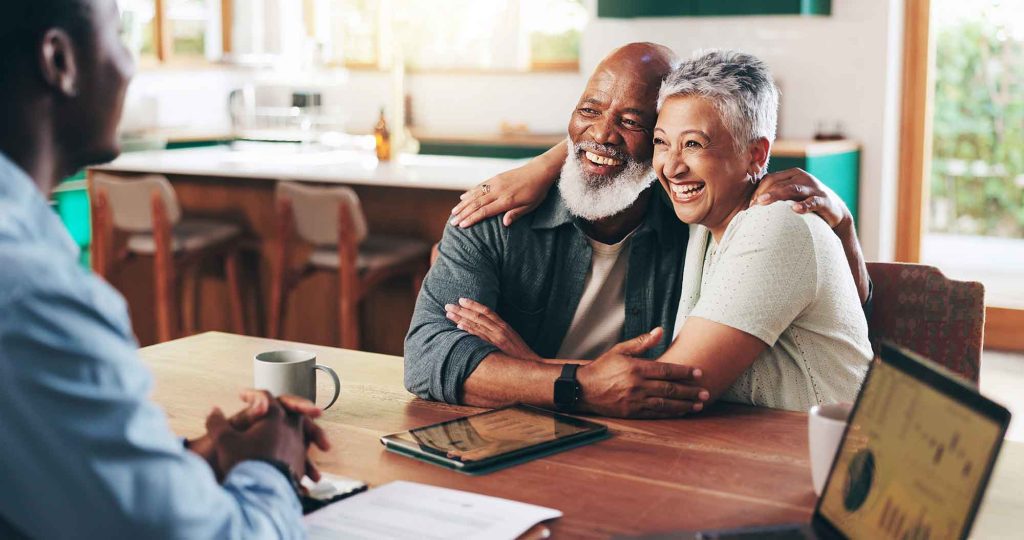 Happy couple meeting with their medicare agent.